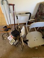 Wide view showing all items including two walking canes, bath seat, bed rail, stethoscope, and exercise bands.