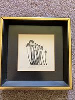 Framed black and white abstract print titled "Windblown" by Robert Dow Reid, depicting stylized organic shapes.