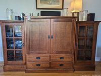 Front view of three-piece oak mission style media cabinet set