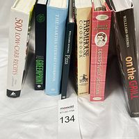 Photo showing all six books standing side by side, titles visible on spines.