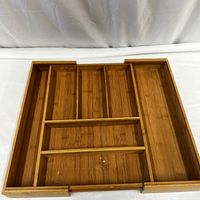 Full view of the bamboo flatware organizer showing 8 separate slots and expandable sides.