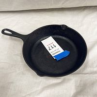 Top view of the black cast iron skillet showing the interior cooking surface and the handle with hole.