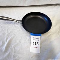 Top and side view of the SCANPAN fry pan showing nonstick surface and stainless steel handle with logo