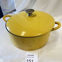Photo of yellow citron enamel cast iron Dutch oven with lid and metal knob, showing signs of wear and some staining on the side.