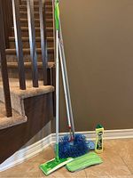 Full lot showing spray mop, blue duster with telescoping handle, Vim cleaner bottle, and microfiber pad.