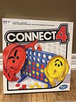 Front of unopened Connect 4 game box showing colorful graphics and brand.