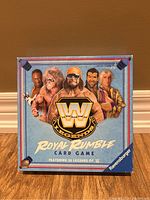 Front view of the WWF Legends Royal Rumble card game box featuring iconic wrestling characters from WWF's legend era with visible box corner damage.