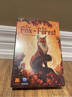 Front view of The Fox In The Forest card game box showing the cover artwork of a fox in a forest setting with autumn colors.