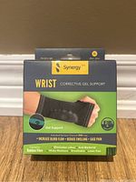 Front view of the Synergy Wrist Corrective Gel Support box showing size XL and key benefits such as gel support, increased blood flow, reduced swelling, and pain relief.