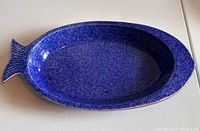 Top view showing the full fish shape and blue speckled glaze