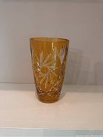 Full view of honey amber crystal vase showing starburst and cross-hatch cut design