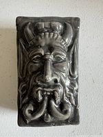 Top view showing the detailed sculpted gargoyle face lid with horns and fangs on the ceramic box.