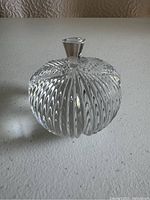 Clear Waterford crystal apple-shaped container with textured diagonal ribbed pattern and faceted top knob lid.