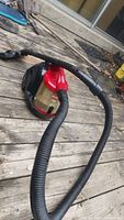 Full view of Bissell Zing canister vacuum cleaner with hose attachment.