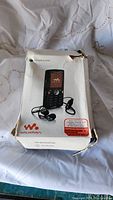 Original Sony Ericsson Walkman phone packaging, box shows wear and damage