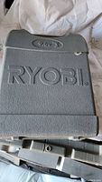 Closed plastic carrying case with Ryobi logo on the lid.
