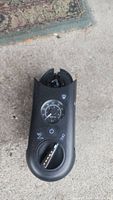 Top view of black portable tire inflator showing pressure gauge, power button, and rotary dial.