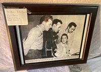 Framed black and white photo of Elvis Presley, Johnny Cash, Carl Perkins, and Jerry Lee Lewis together labeled Million Dollar Quartet.