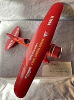 Red die cast steel model plane with N1994 marking and yellow advertising text 'HARDDRIFT TOOLS 1-800-243-2567' on the wing. Model has working wheels and a spinning propeller.