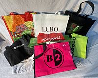 Overview of 8 reusable bags in various colors and brands, including canvas and plastic materials.