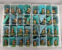 Two cases each containing 32 miniature ninja figures, separated by foam padding.