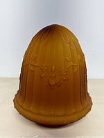 Front view of amber Art Nouveau glass lampshade showing floral and leaf embossing