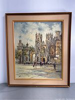 Full view of the framed original signed painting depicting a cathedral scene with people.