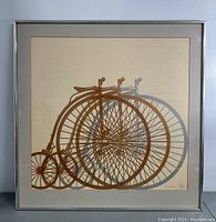 Full view of framed and matted limited edition print featuring tricycle design in brown and gray tones.