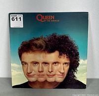 Front cover of Queen's The Miracle vinyl record album featuring combined portraits of band members.