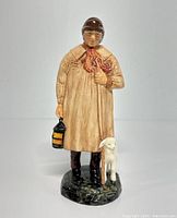Front view of Royal Doulton figurine featuring a shepherd holding a lantern and staff with a lamb beside him, standing on a grass-textured base.