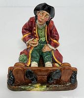 Front view showing seated man in stocks, facial details, glaze colors