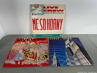 Three vinyl albums displayed side by side with The 2 Live Crew on top and Live Wire and Earth Quake below