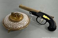 Two retro lighters together: one spaceship style and one firearm style.