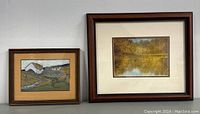 Both framed artworks side by side on wall, showing relative sizes and framing styles