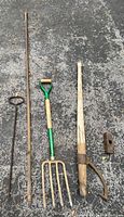 All five vintage lawn and garden tools laid out on pavement showing overall condition and design.