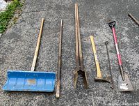 Overview of all six vintage tools: blue snow shovel, iron poker, post hole digger, iron wedge, Sears axe, Brute ice scraper