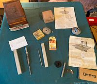 Photo showing entire assortment of wood cutting tools, including wooden box, cutting tools, drill bits, washers, and instruction sheets.
