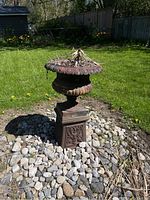 Overall view of urn on pedestal in yard