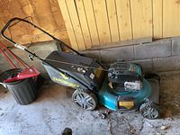 Side view of mower with bag attached showing brand logo and overall condition