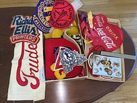 Overall view of boxed patches and pins including Coca Cola round patch, school team patches, letter patches, and Trudeau patch