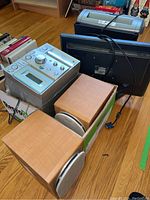 Sony CMT-CP101 Micro HiFi stereo system, two bookshelf speakers, Acer LCD monitor, and office paper shredder arranged on floor.