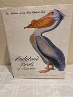 Front cover of the book's dust jacket showing a colored pelican illustration and title.