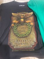 Black tee-shirt with detailed graphic featuring an owl, wreath, and text for The Who & Grateful Dead concerts at Oakland Stadium October 9-10.