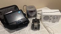 All four items together: Tivoli radio, Curtis CD player, Philips DVD player with case, and Brownie Hawkeye camera