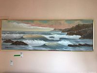 Front view of the framed seascape ocean wave painting hung on a wall, showing full artwork and signature.