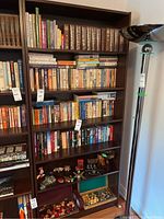 Full view of the bookshelf filled with books and some decorative items, to show size and design.