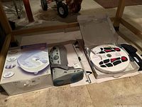 Lot arranged on floor including boxed Homedics foot bath, medical boot, and foot circulation promoter.