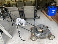 Wide angle side view of the Murray Pro Series lawn mower with grass collection bag attached, showing overall condition and setup.