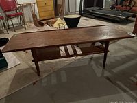 Side profile showing overall form, tapered legs and stretcher dowels