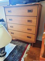 Front view of dresser showing four drawers and recessed handles